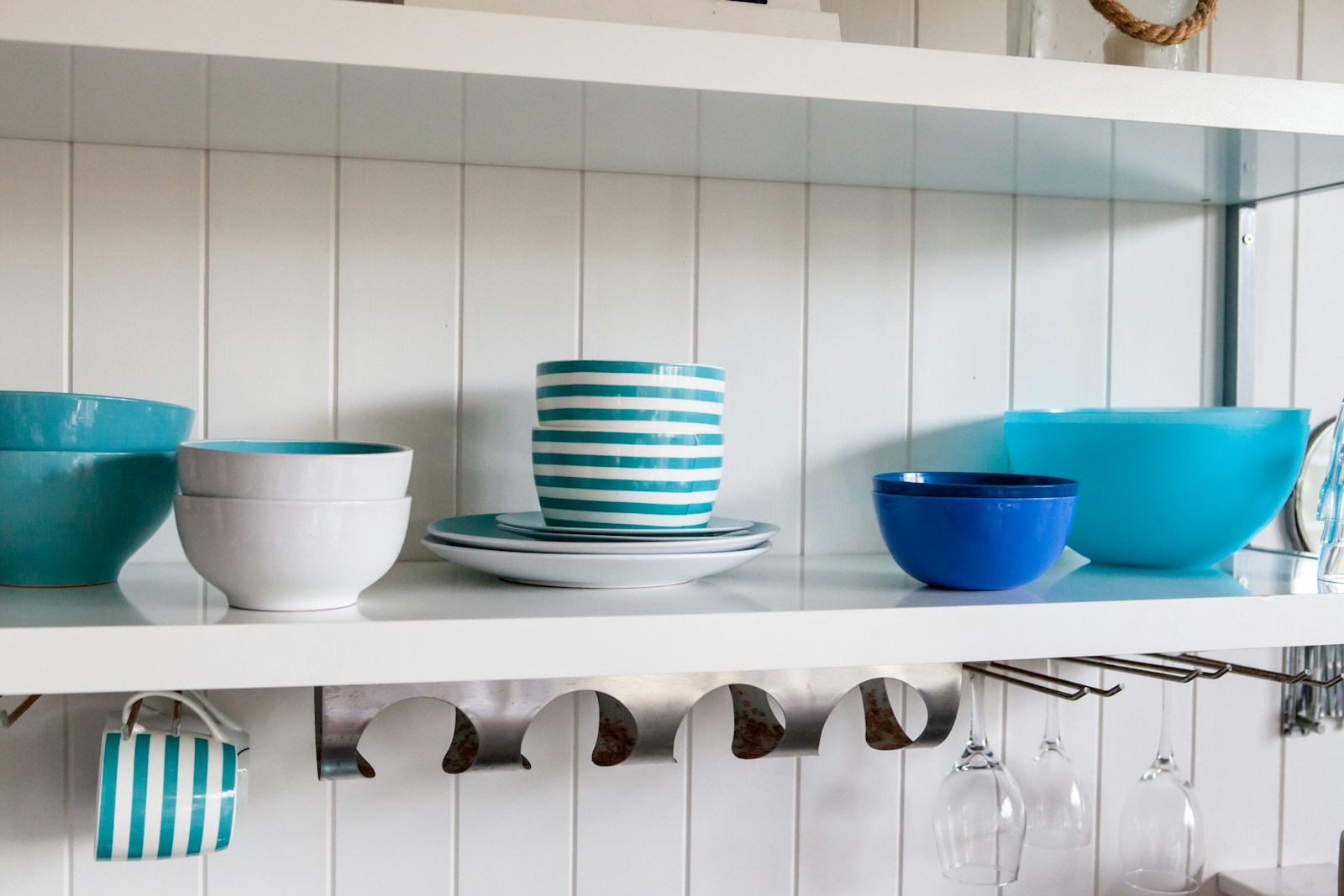 Blue and white ceramic bowls arranged on a white shelf
